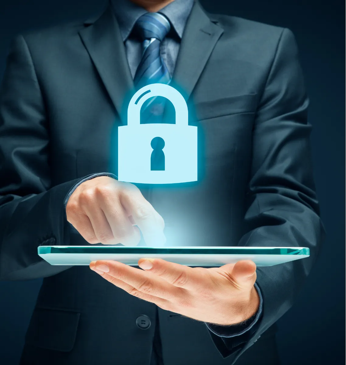 cybersecurity-2 A man in a suit uses a tablet with a glowing padlock symbol, representing digital security.